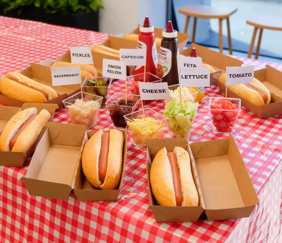 hot dogs in rolls in boxes with sauces and toppings to build your own hot dog